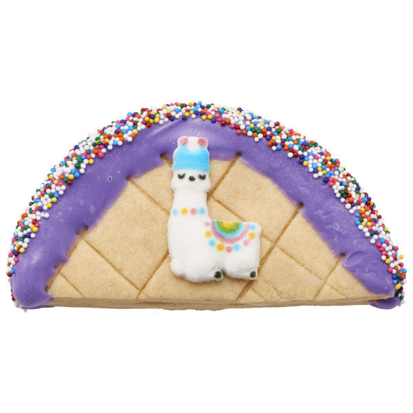 Decorated cookie taco with llama sugar decoration and rainbow nonpareils.