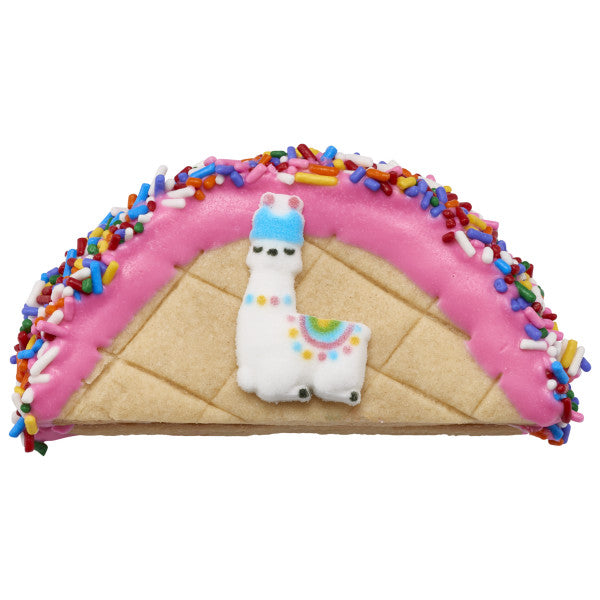 Decorated cookie taco with llama sugar decoration and rainbow jimmies.