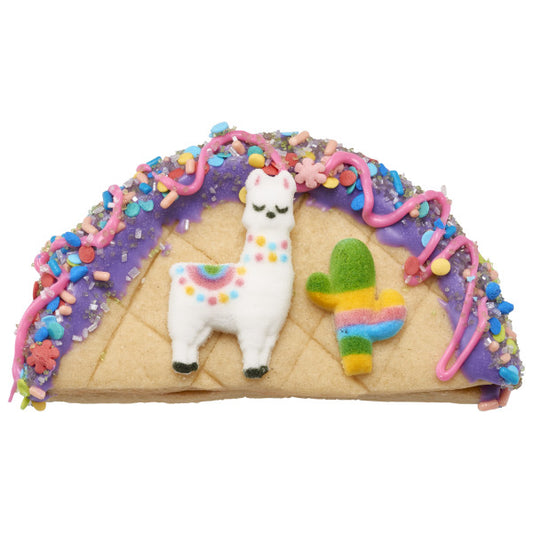 Decorated cookie taco with llama and cactus sugar decorations.
