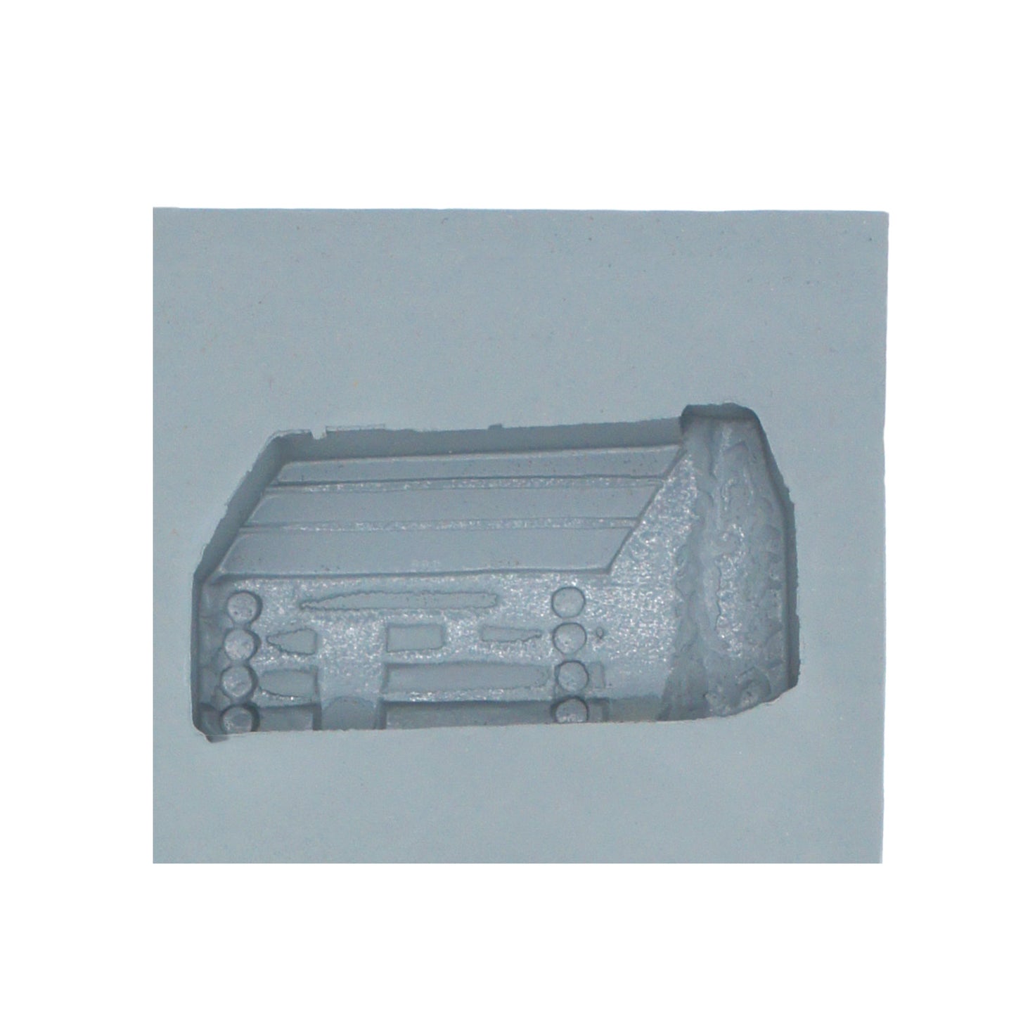 Close-up of log cabin rubber mint mold cavity with stacked log and pitched roof detailing for rustic-themed candy making