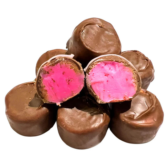 Chocolate-covered candies with a vibrant pink maraschino cherry cream center, two cut open to reveal the filling.