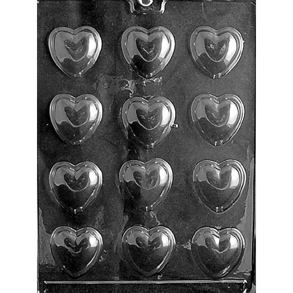 Clear plastic chocolate mold with 12 medium smooth domed heart cavities arranged in a grid for making classic heart-shaped chocolates.