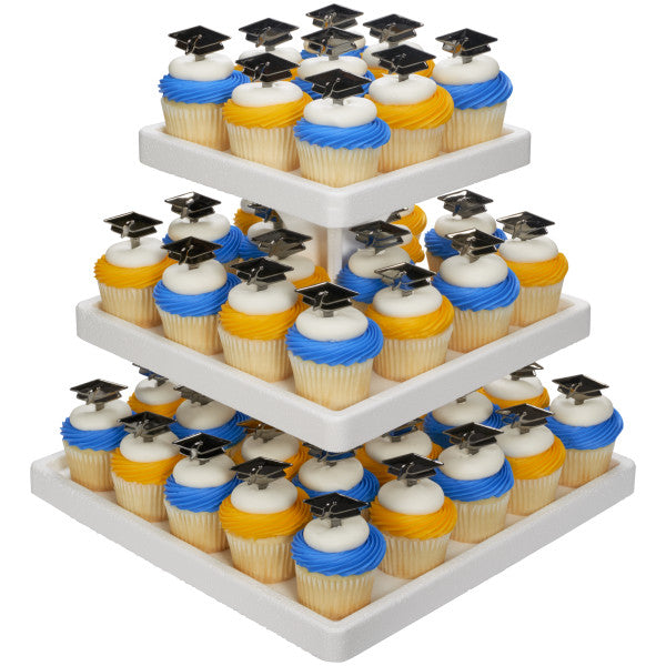 Tiered cupcake stand with blue, yellow, and white frosted cupcakes topped with graduation caps.
