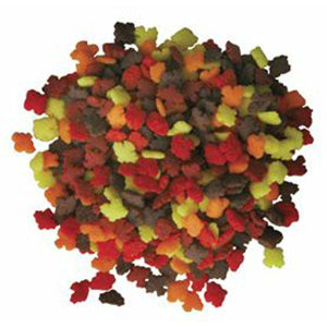 Pile of mini autumn leaf-shaped sprinkles in assorted fall colors.