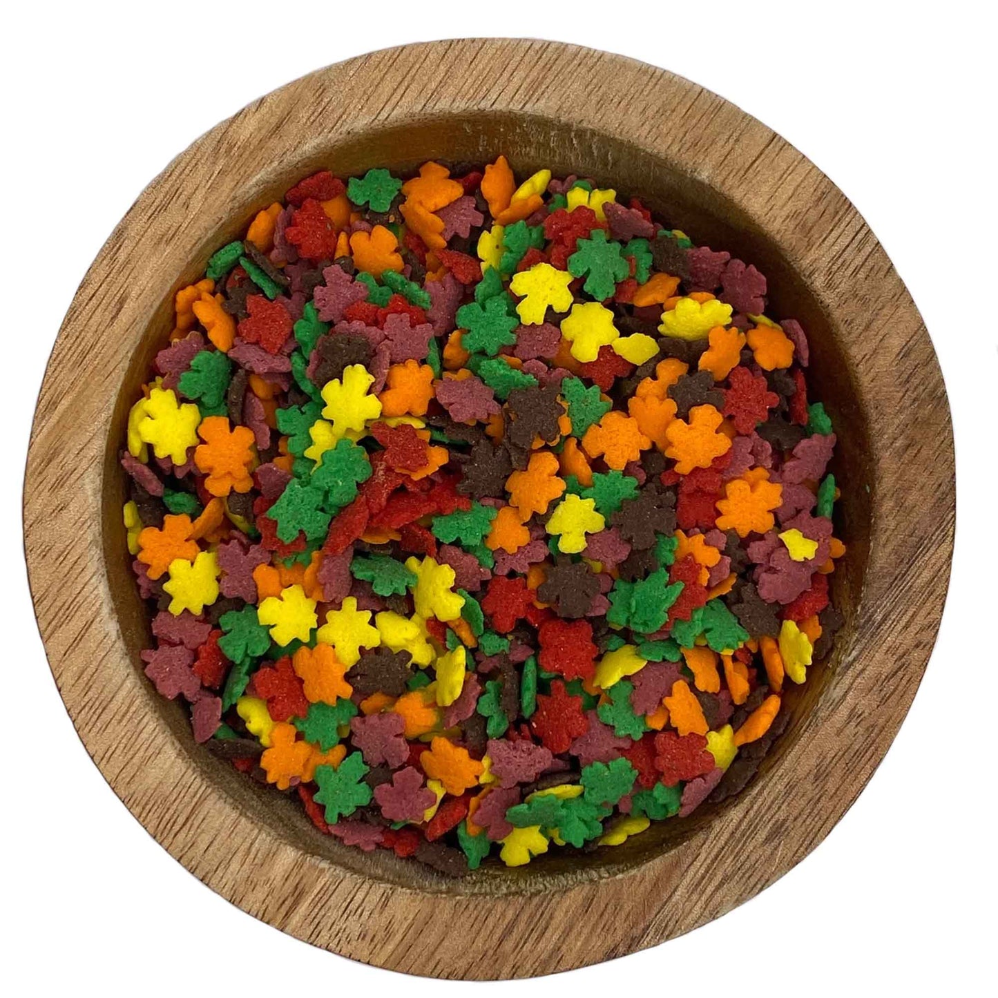 Close-up of mini autumn leaf quins sprinkles in red, orange, yellow, and brown, packaged in a 4 oz container.
