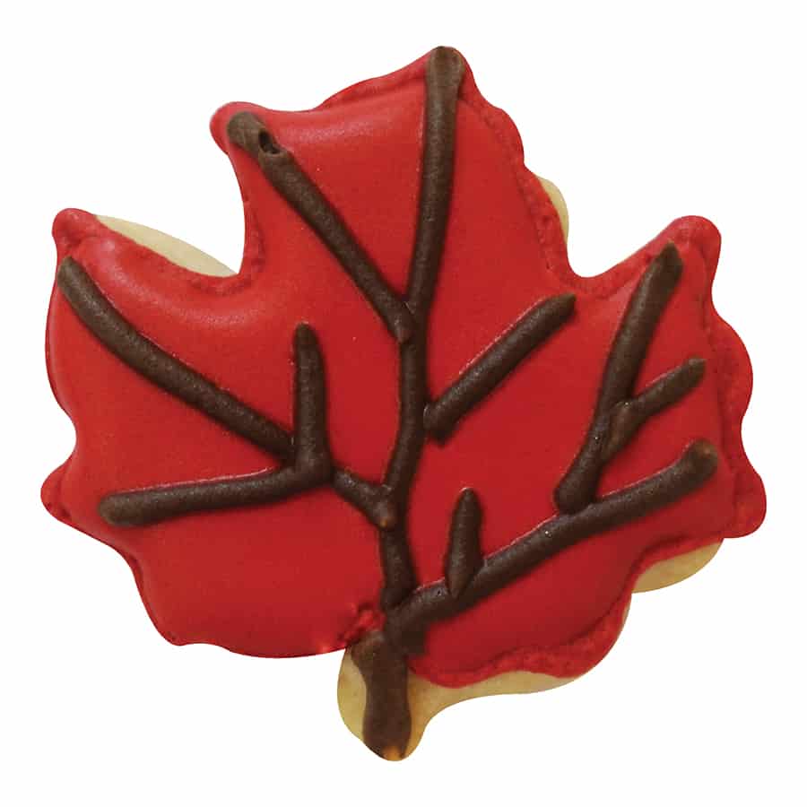 Mini maple leaf-shaped sugar cookie decorated with red icing and brown vein details.