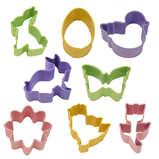 Eight mini Easter cookie cutters arranged on a white background in pastel colors, including two bunny shapes, a butterfly, an egg, a chick, a duck, a daisy flower, and a tulip.