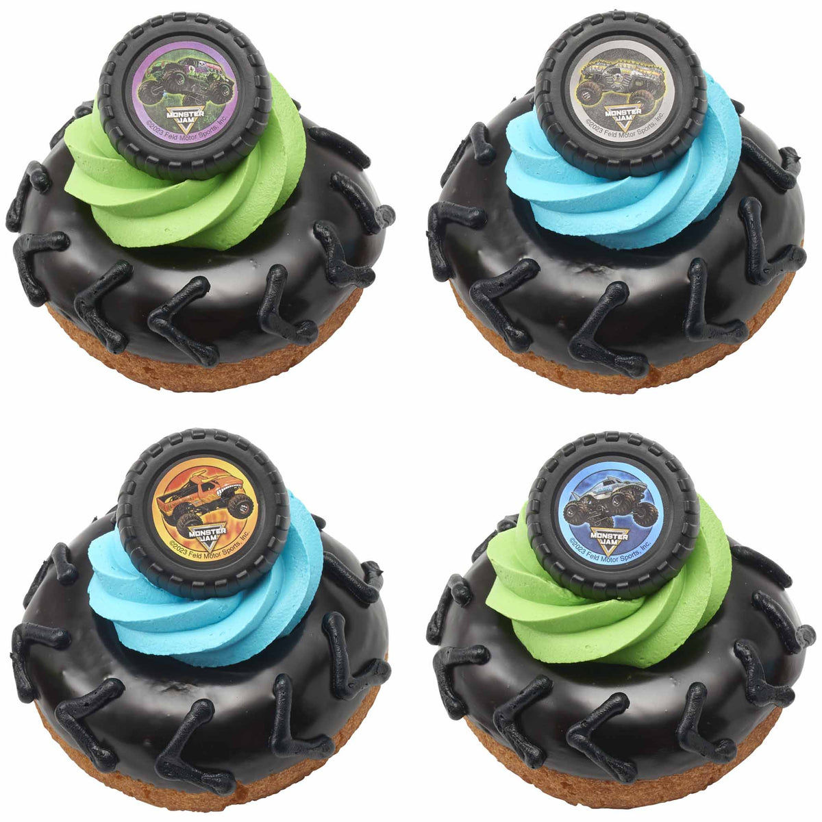 Four black-glazed tire donuts decorated with tread marks, colorful frosting swirls, and Monster Jam monster truck topper rings