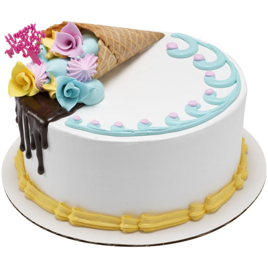 White cake decorated with an ice cream cone filled with pastel flowers, chocolate drip, and a pink “Happy Mother’s Day” pick inserted at the top.