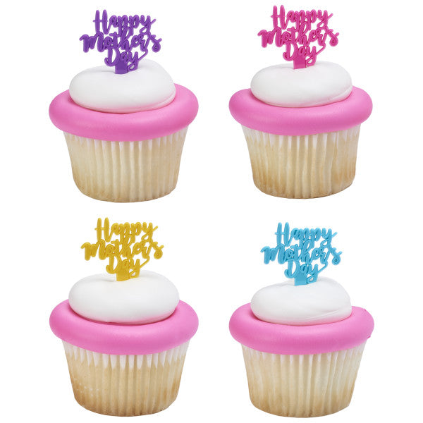 Four cupcakes with pink fondant rims and white frosting domes, each topped with a different colored “Happy Mother’s Day” pick.