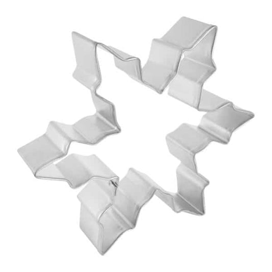 Angled view of a narrow snowflake cookie cutter showing sharp, zigzag-style edges, perfect for cutting festive holiday cookie dough.