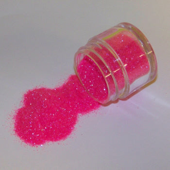 Bright hot pink Galaxy Glitter Dust spilling from a jar, shimmering vibrantly with cool iridescent sparkle on a white surface.