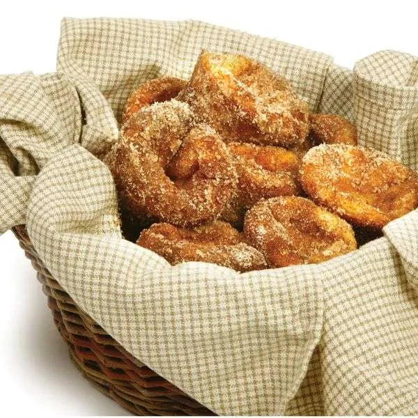 Basket of golden-brown popovers coated in cinnamon sugar, lined with a checkered cloth.