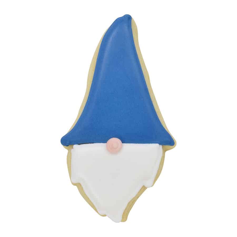 Decorated gnome-shaped cookie with a blue hat, white beard, and pink nose.