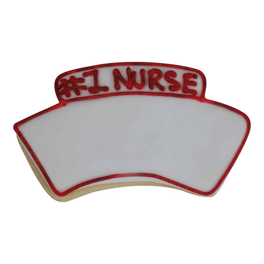 Decorated nurse hat-shaped cookie with white icing and red piped trim, featuring the words '#1 Nurse' written in red icing.