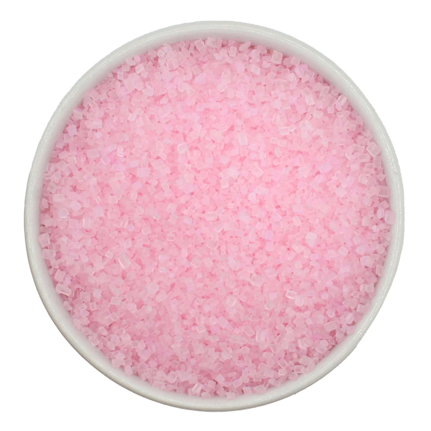 Top-down view of a white bowl filled with pastel pink coarse sanding sugar crystals, showing chunky sparkling granules in a soft blush-pink color.