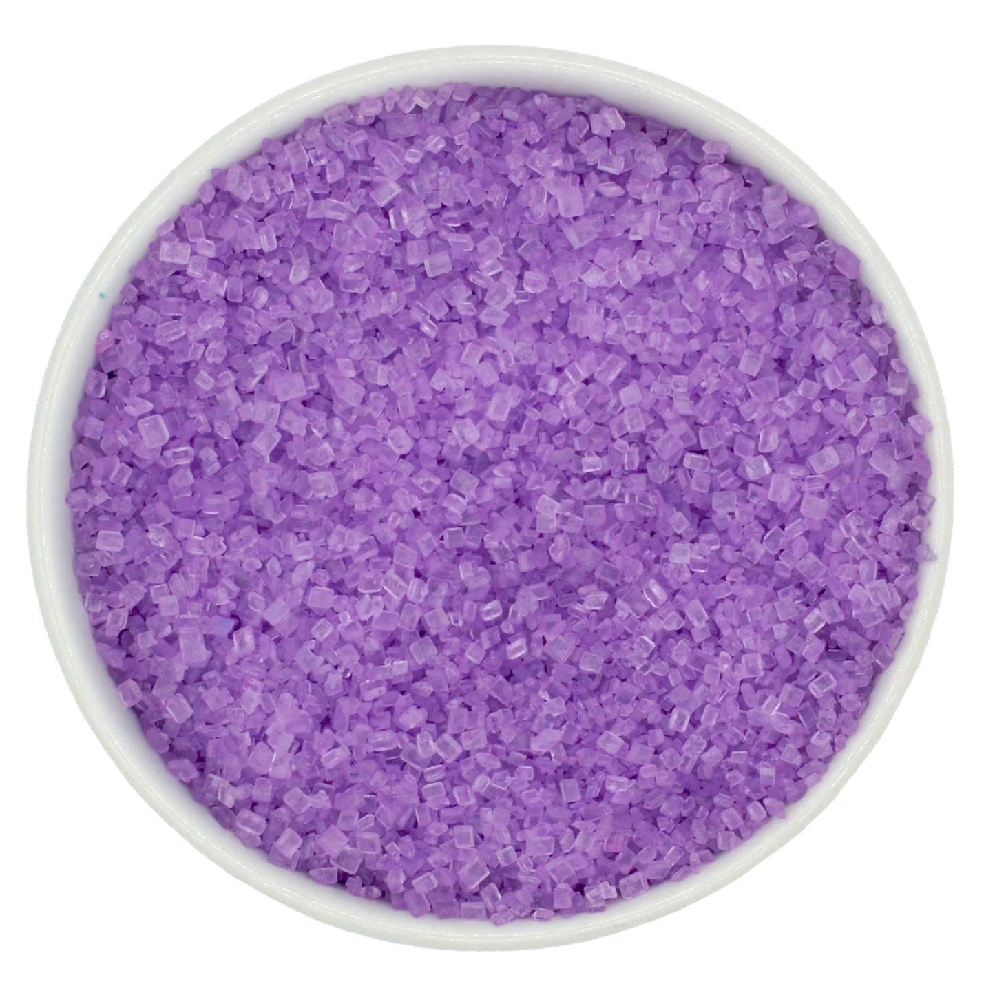 Top-down view of a white bowl filled with pastel purple coarse sanding sugar crystals, showing light violet, chunky granules with a clear sparkling shine.