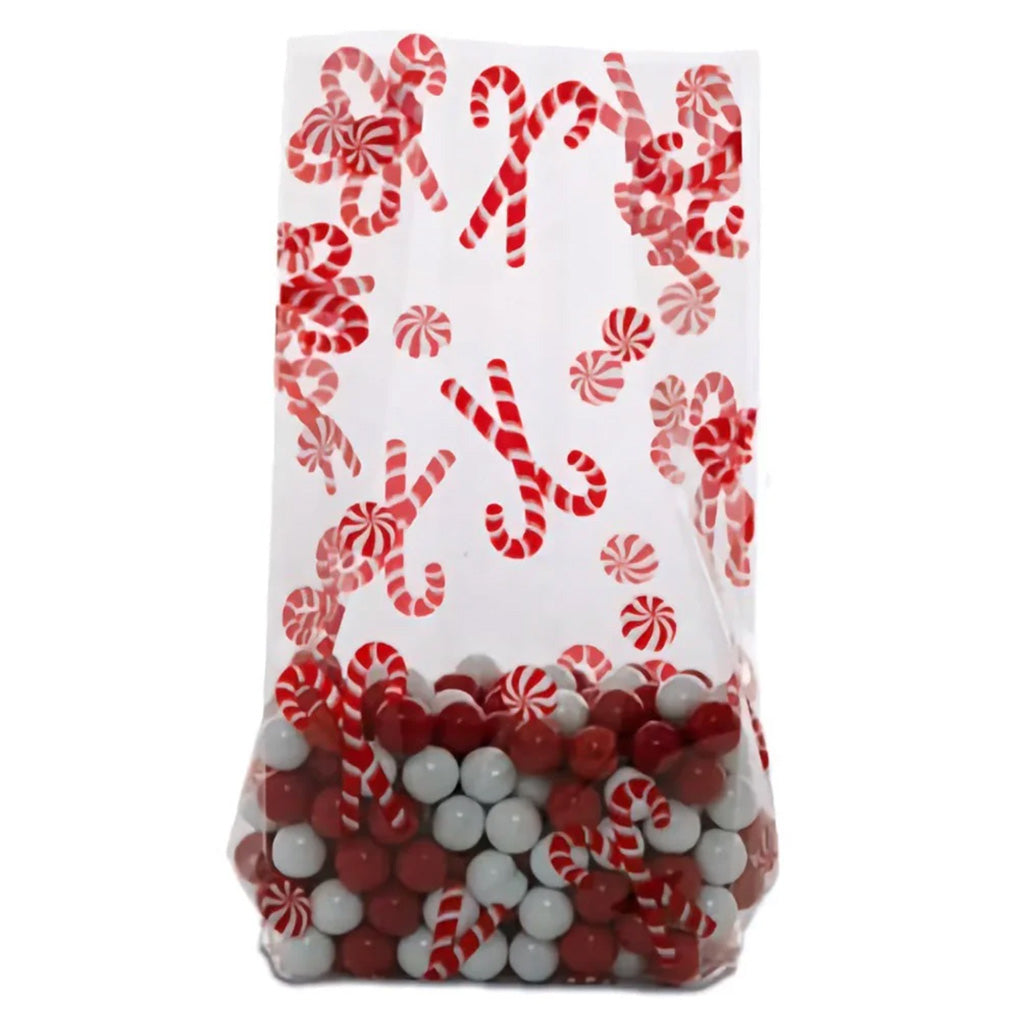 Clear large cello treat bag printed with red-and-white candy canes and peppermint swirl candies, shown filled with red and white candy balls near the bottom.