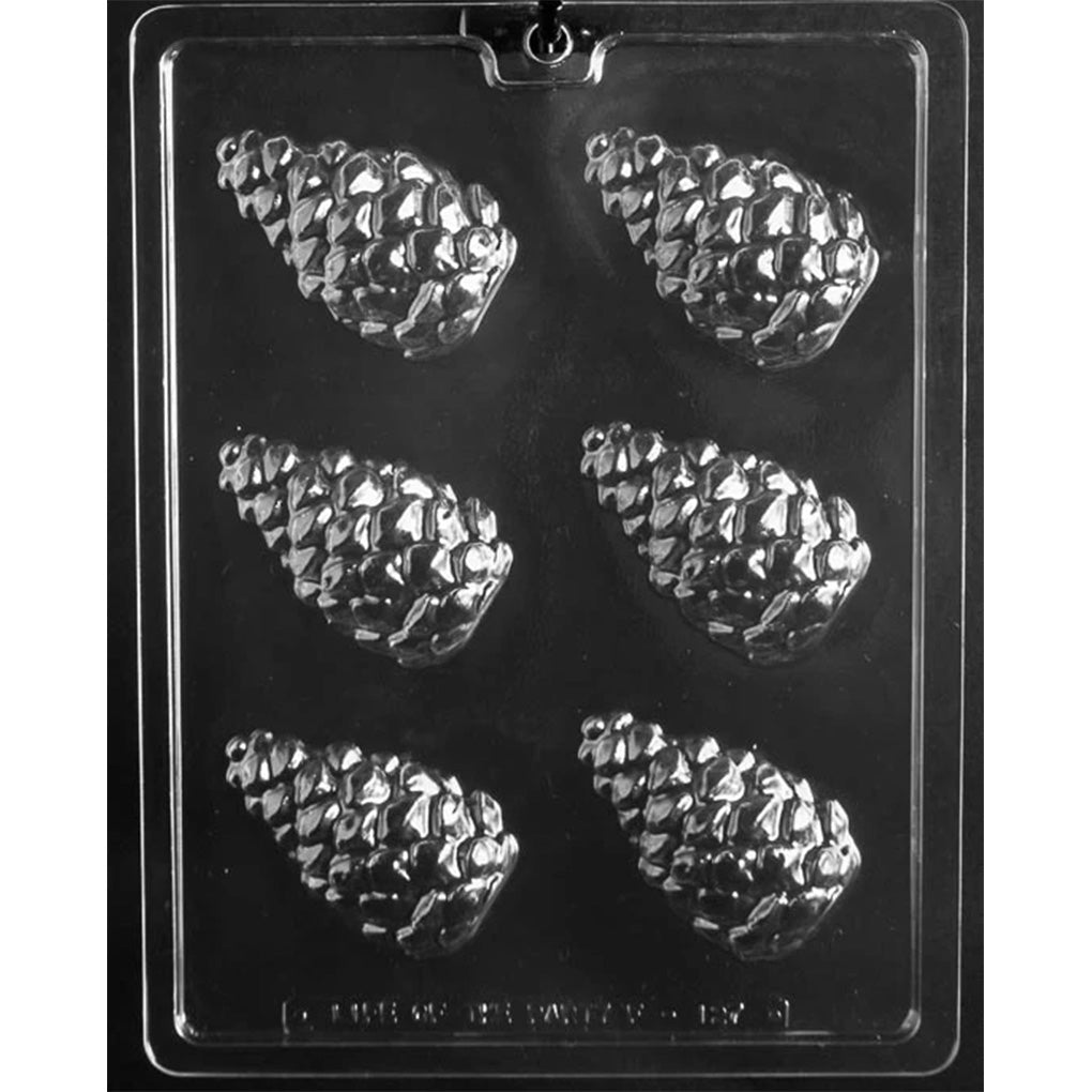 Clear plastic chocolate mold with six pinecone-shaped cavities arranged in two columns, each pinecone showing a raised, layered scale texture.