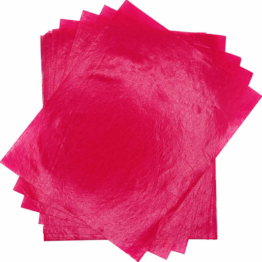 Overlapping stack of vivid pink 4" x 5" wax caramel and taffy wrapper sheets displayed against a white background.