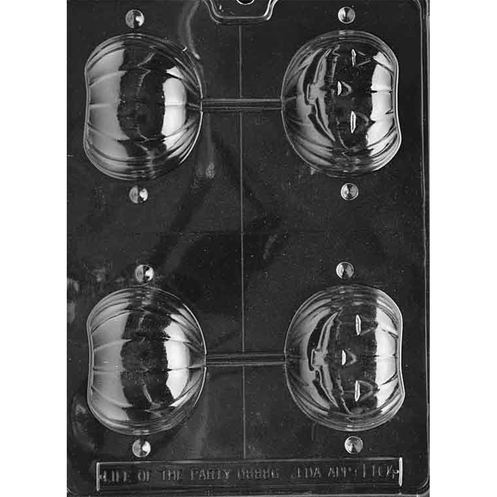 Clear plastic 3D chocolate mold photographed on a black background with four pumpkin cup cavities in two columns, showing smooth pumpkin halves on the left and jack-o’-lantern face halves on the right, connected by thin bridges.