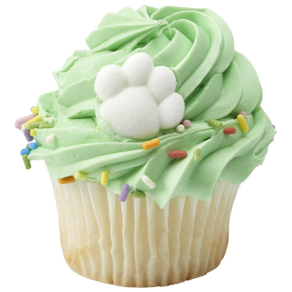 Green frosted cupcake topped with rainbow sprinkles and a white sugar puppy paw.