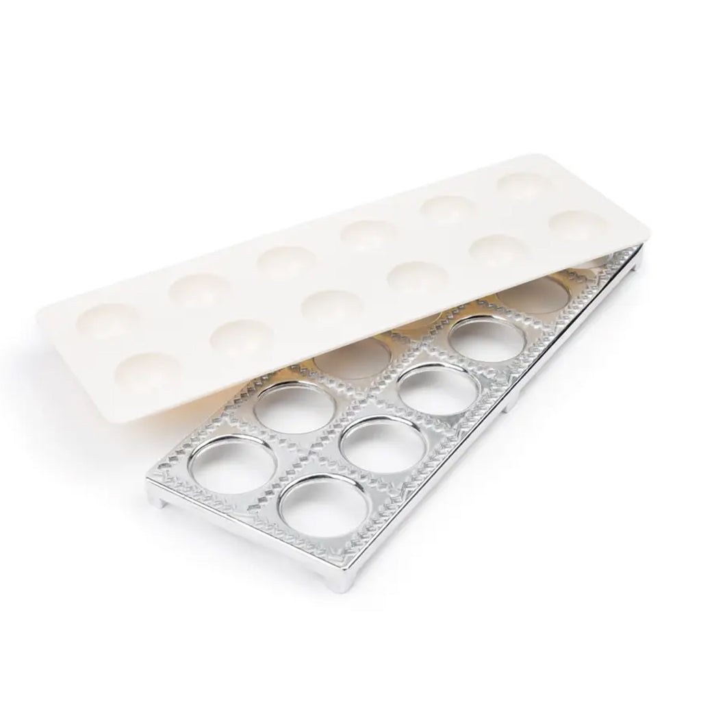 Ravioli maker set with white plastic press and aluminum cutting frame with round openings