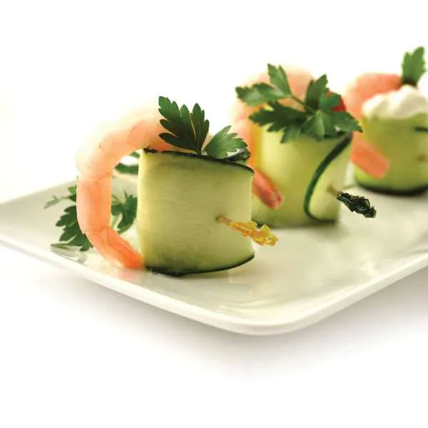 Appetizer platter with shrimp and cucumber rolls secured with colorful cocktail picks, garnished with parsley