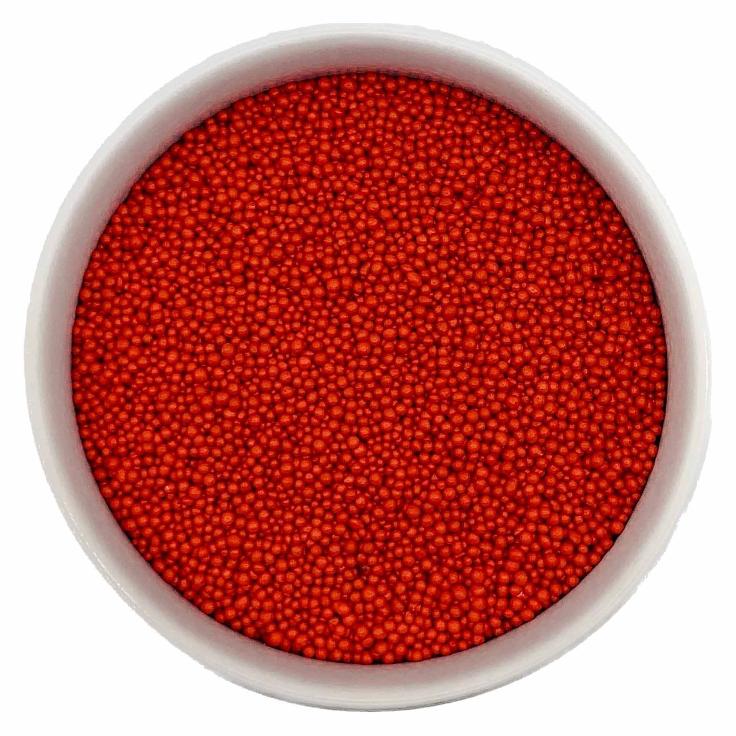Bowl of red nonpareil sprinkles on a white background.