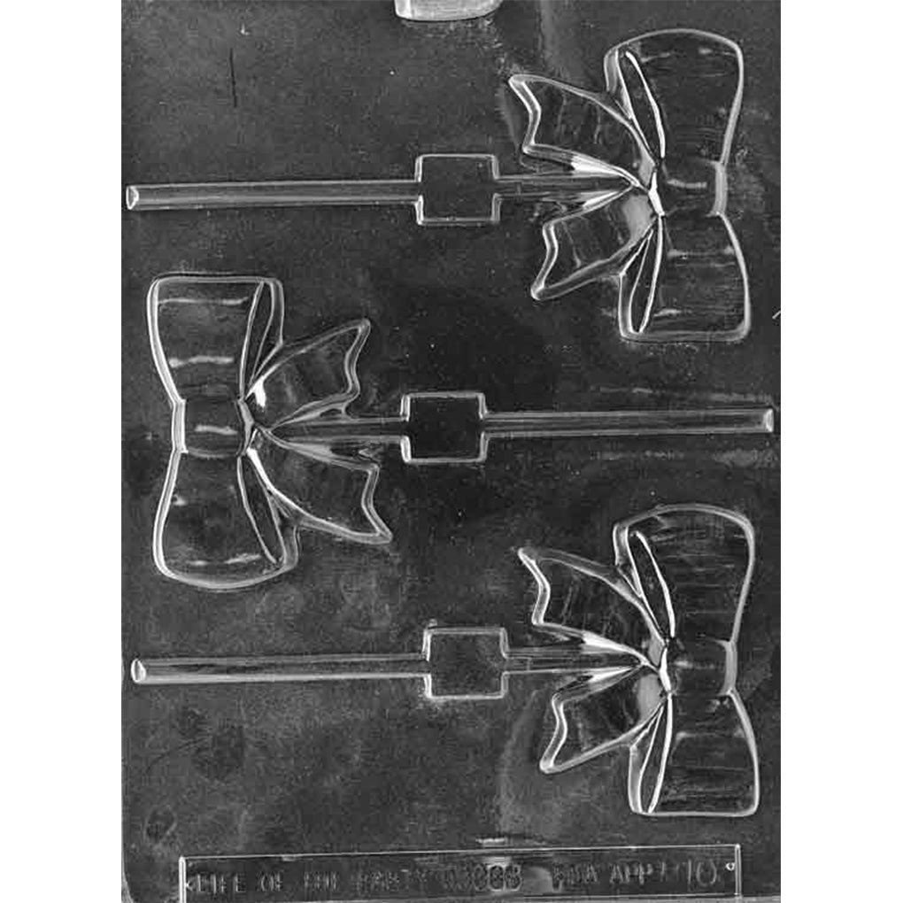 Clear plastic chocolate lollipop mold with three ribbon bow cavities and stick channels, showing folded bow loops and ribbon tails.