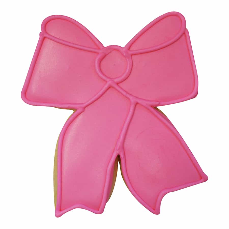 Pink bow-shaped cookie decorated with royal icing and piped details.