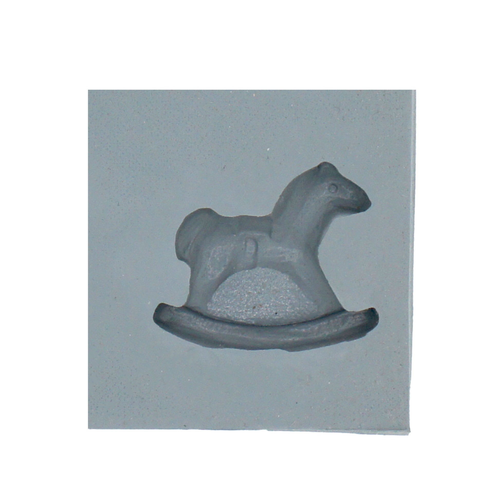 Close-up of a rocking horse-shaped cavity in a natural rubber mint mold, ideal for baby shower-themed cream cheese mints or chocolates.