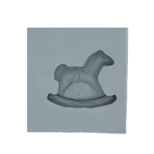 Close-up of a rocking horse-shaped cavity in a natural rubber mint mold, ideal for baby shower-themed cream cheese mints or chocolates.