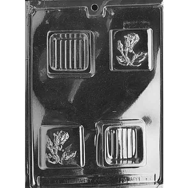Clear plastic chocolate mold with four small square cavities: two squares embossed with a raised rose and leaves, and two squares with a raised striped panel design; shown on a dark background.