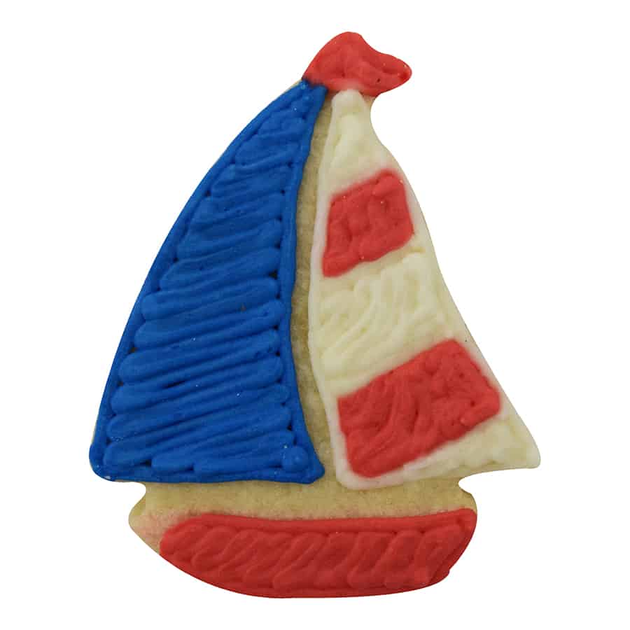 Decorated sailboat sugar cookie with red, white, and blue icing, designed for a patriotic or nautical theme.