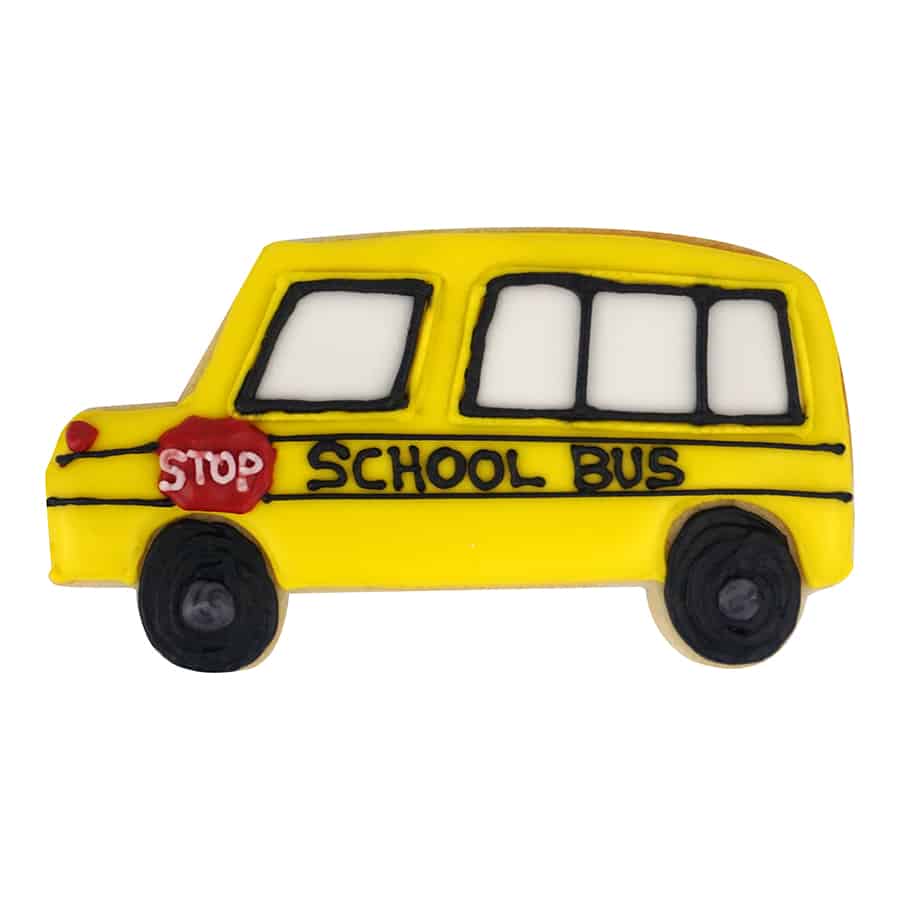 Decorated school bus-shaped cookie with yellow icing, black wheels, and a red stop sign detail.