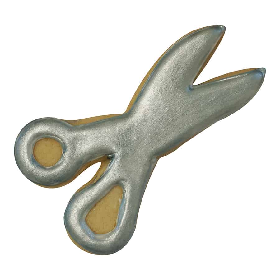 Metallic silver-decorated scissors cookie with a realistic design, featuring shiny edible paint on a sugar cookie base.