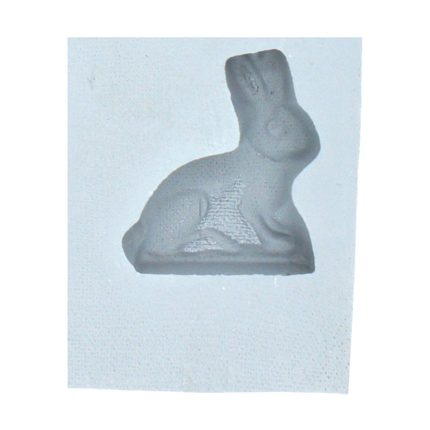 Close-up of a small rabbit-shaped cavity in a natural rubber mint mold, perfect for making cream cheese mints or spring-themed confections.