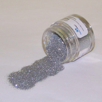 Silver Galaxy Glitter Dust scattered from a tipped jar, sparkling with a metallic shimmer.