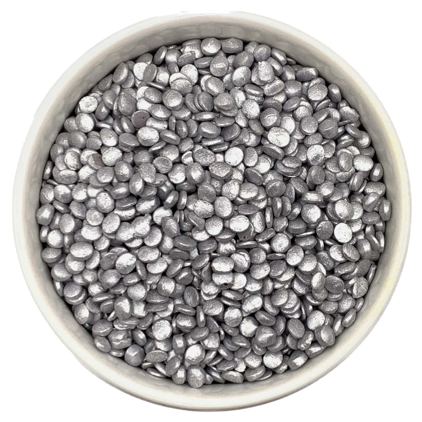 Metallic silver edible quins sprinkles in a white bowl, shown in a confetti shape, ideal for decorating cakes, cupcakes, cookies, and party desserts
