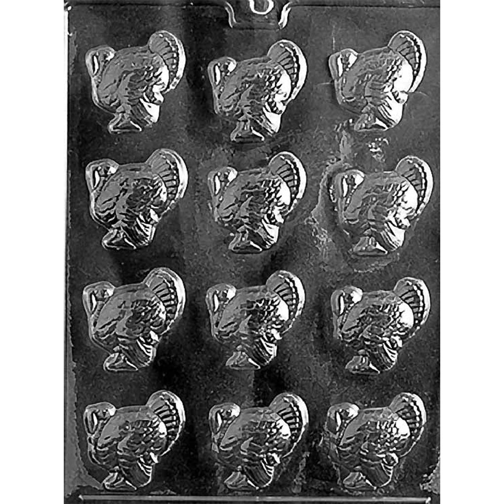 Plastic chocolate mold with twelve small turkey-shaped cavities, each showing a side-profile turkey with a fanned tail.