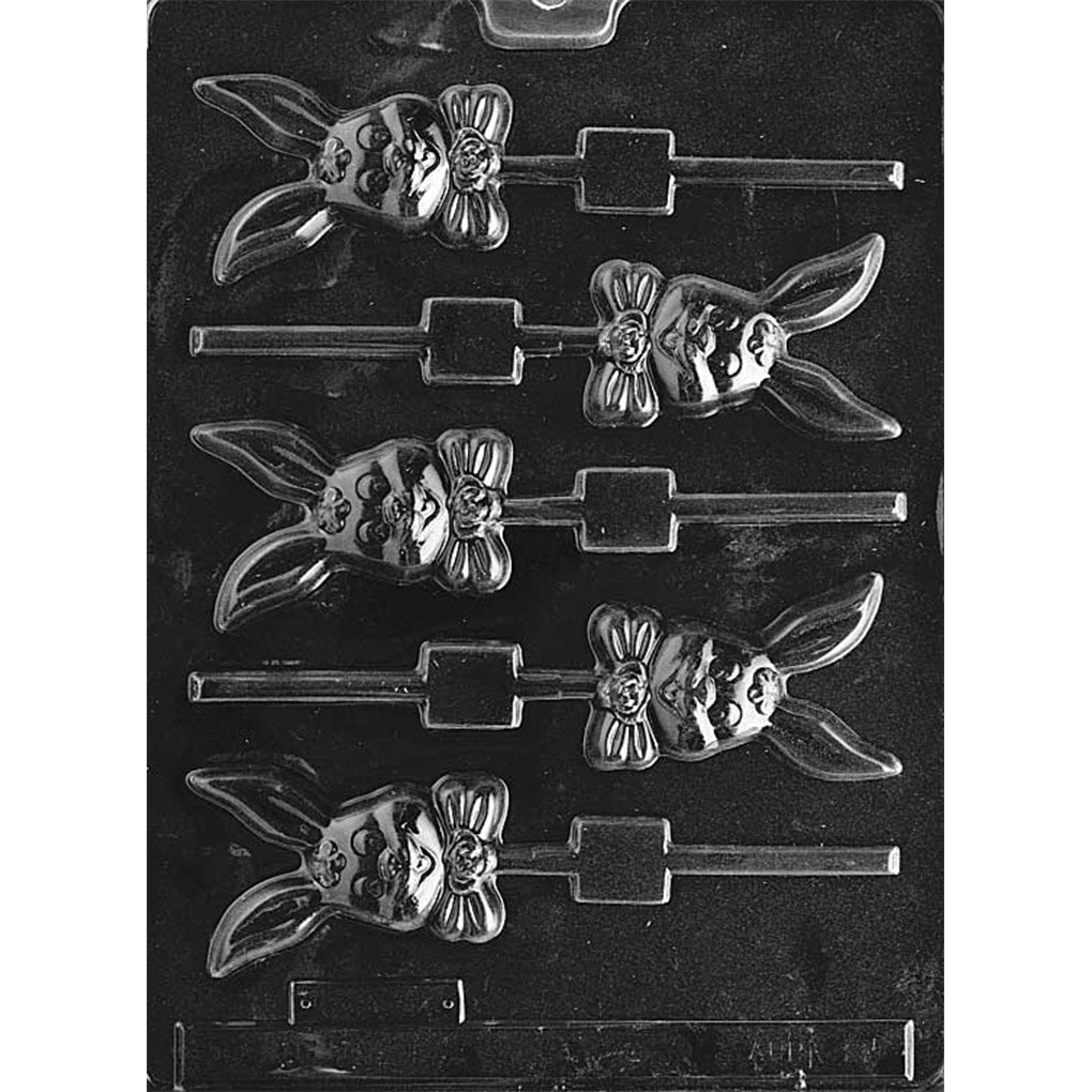 Clear plastic smiling long-eared bunny chocolate lollipop mold with five bunny face cavities featuring floppy ears, a bow tie, and built-in stick channels.