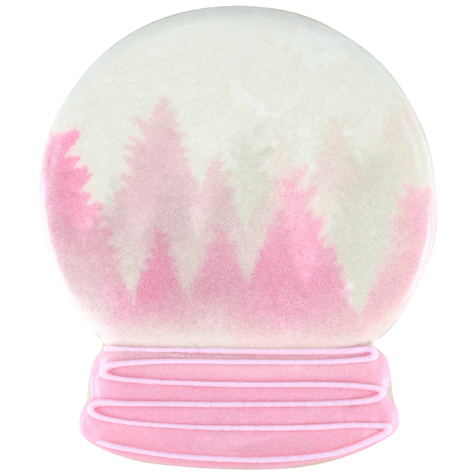 Decorated cookie resembling a snow globe with a pink and white winter scene featuring trees and a pastel-colored base.