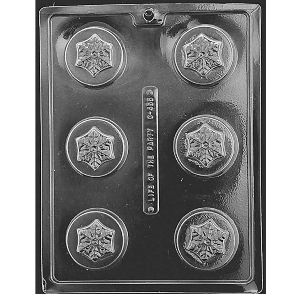 Snowflake chocolate-covered sandwich cookie mold with six round cavities, each featuring a detailed snowflake design in the center