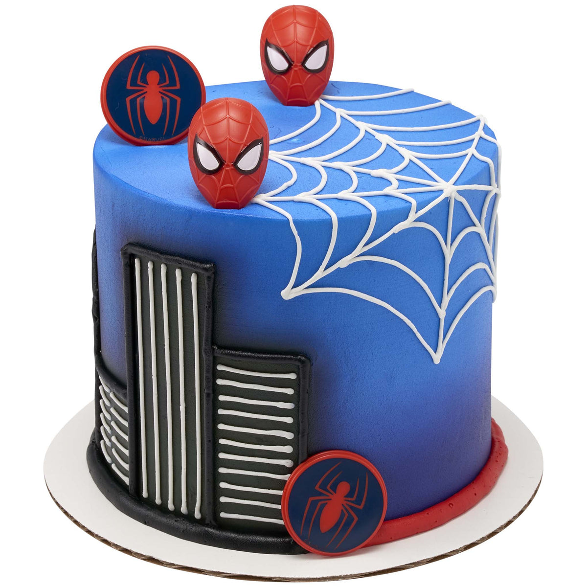 Spider-Man mask and spider symbol rings decorating a blue cake with white piped webs and a black city skyline