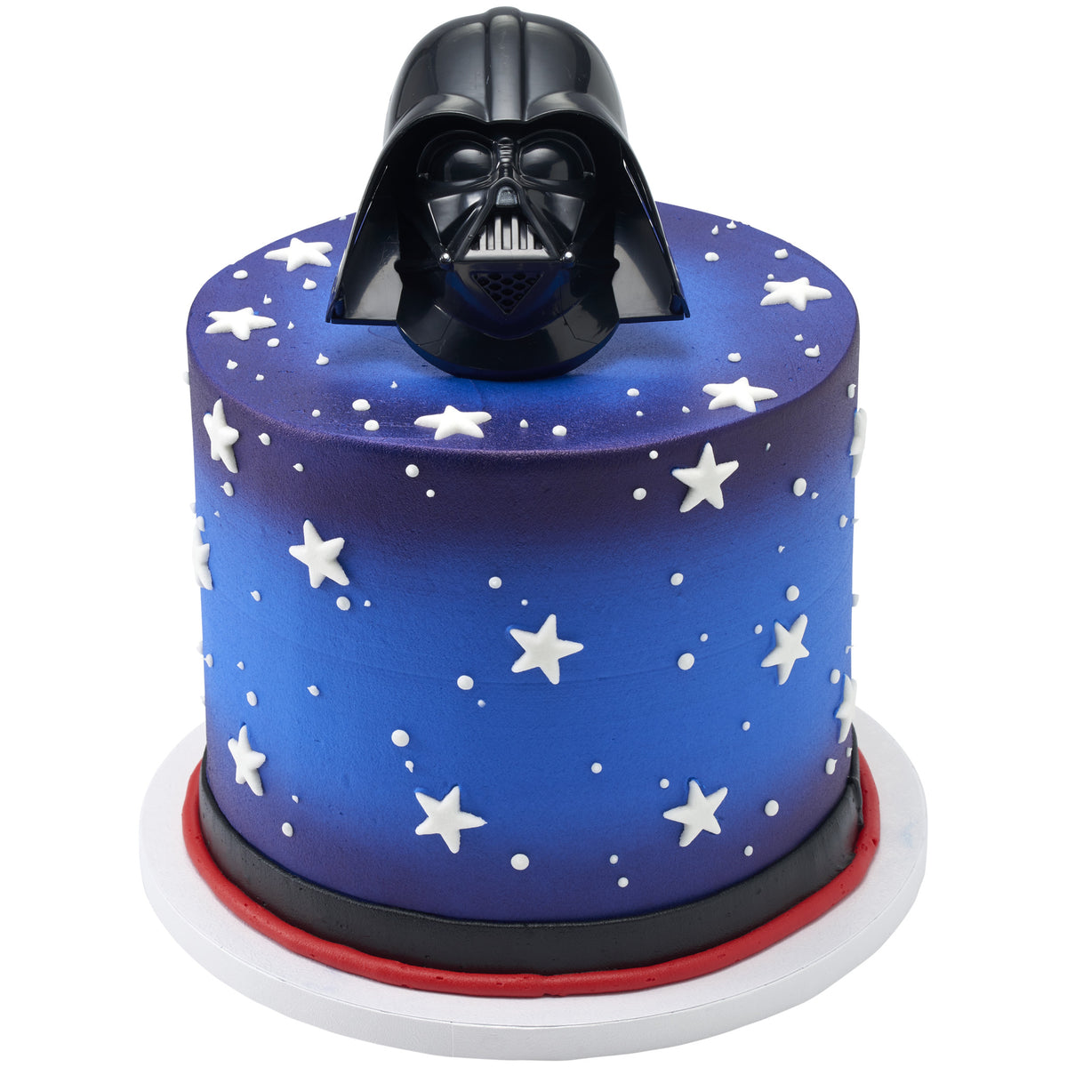 Tall round blue and purple cake decorated with scattered white pressed sugar stars and dots, finished with black and red borders and a glossy black helmet-shaped topper.