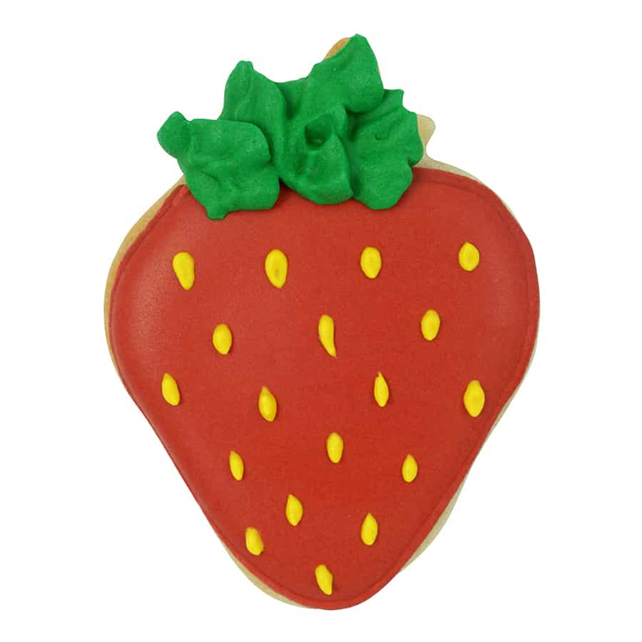 Strawberry-shaped cookie decorated with red icing, green icing leaves, and yellow seed details.