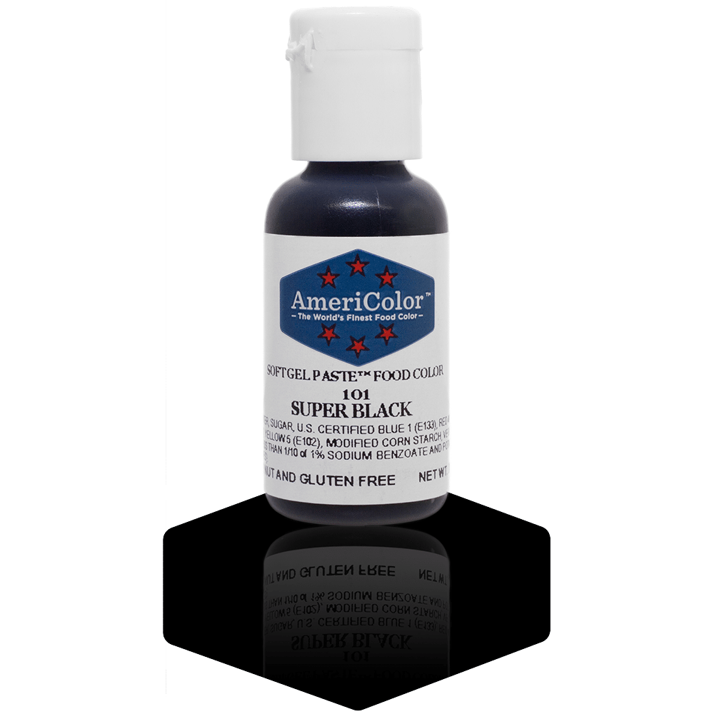 A bottle of AmeriColor Super Black soft gel paste food coloring, featuring a white cap and blue label with red stars, standing on a glossy black surface with its reflection visible.