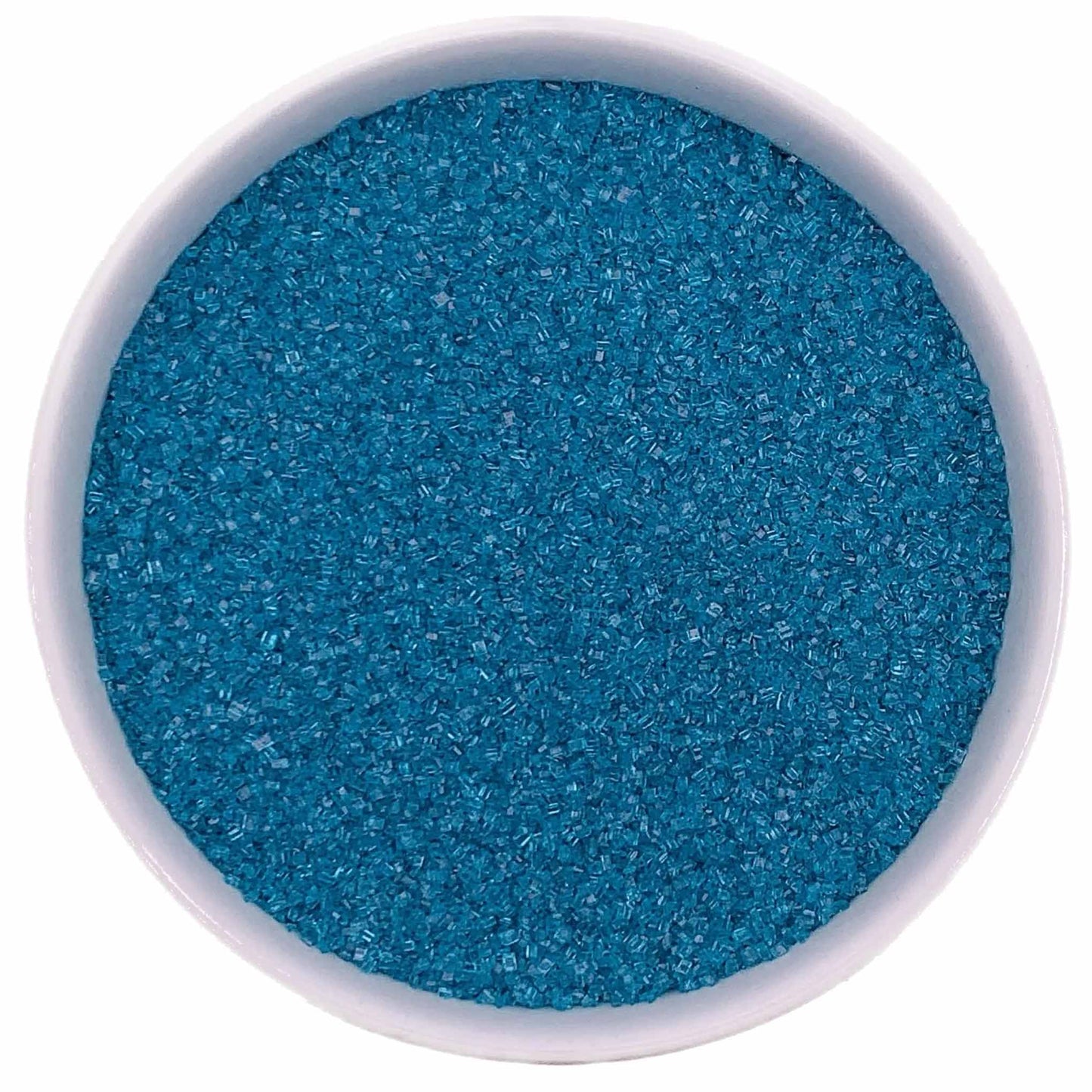 Top-down view of a white bowl filled with teal fine sanding sugar, showing tiny sparkling blue-green crystals with a smooth, even texture.