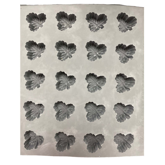 Full sheet of three-leaf rubber mint mold showing multiple cavities arranged in rows for batch production